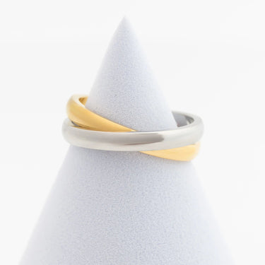 Two-toned gold and silver ring on a white stand