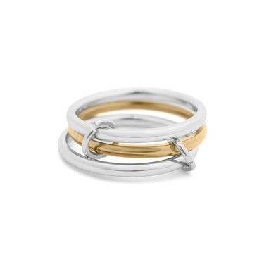 Three interlocking rings, two silver and one gold, on a white background
