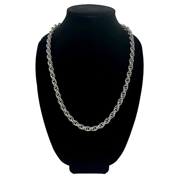 Stainless steel chain necklace with circle knots on a black velvet bust.