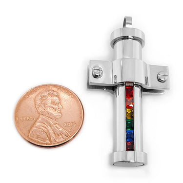 Stainless steel Cubic Zirconia rainbow pride pendant with a penny for scale.