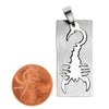 Stainless steel cutout scorpion pendant with a penny for scale.