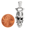 Stainless steel black eyed skull pendant with a penny for scale.