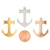 Stainless steel blank anchor pendants in three different colors with a penny for scale.