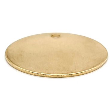 Brass blank round holed pendant at an angle.