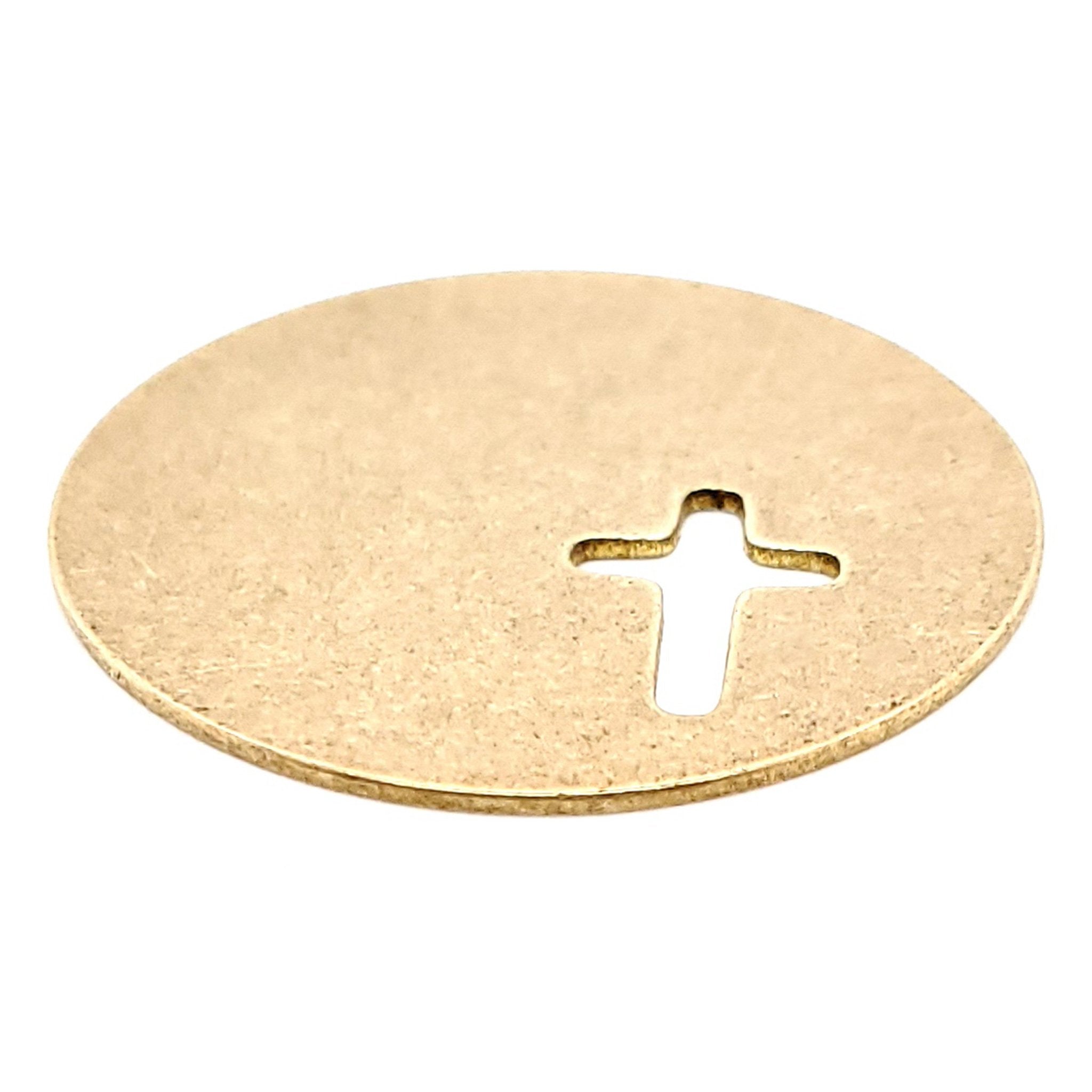 Brass blank round cross cutout pendant at an angle.