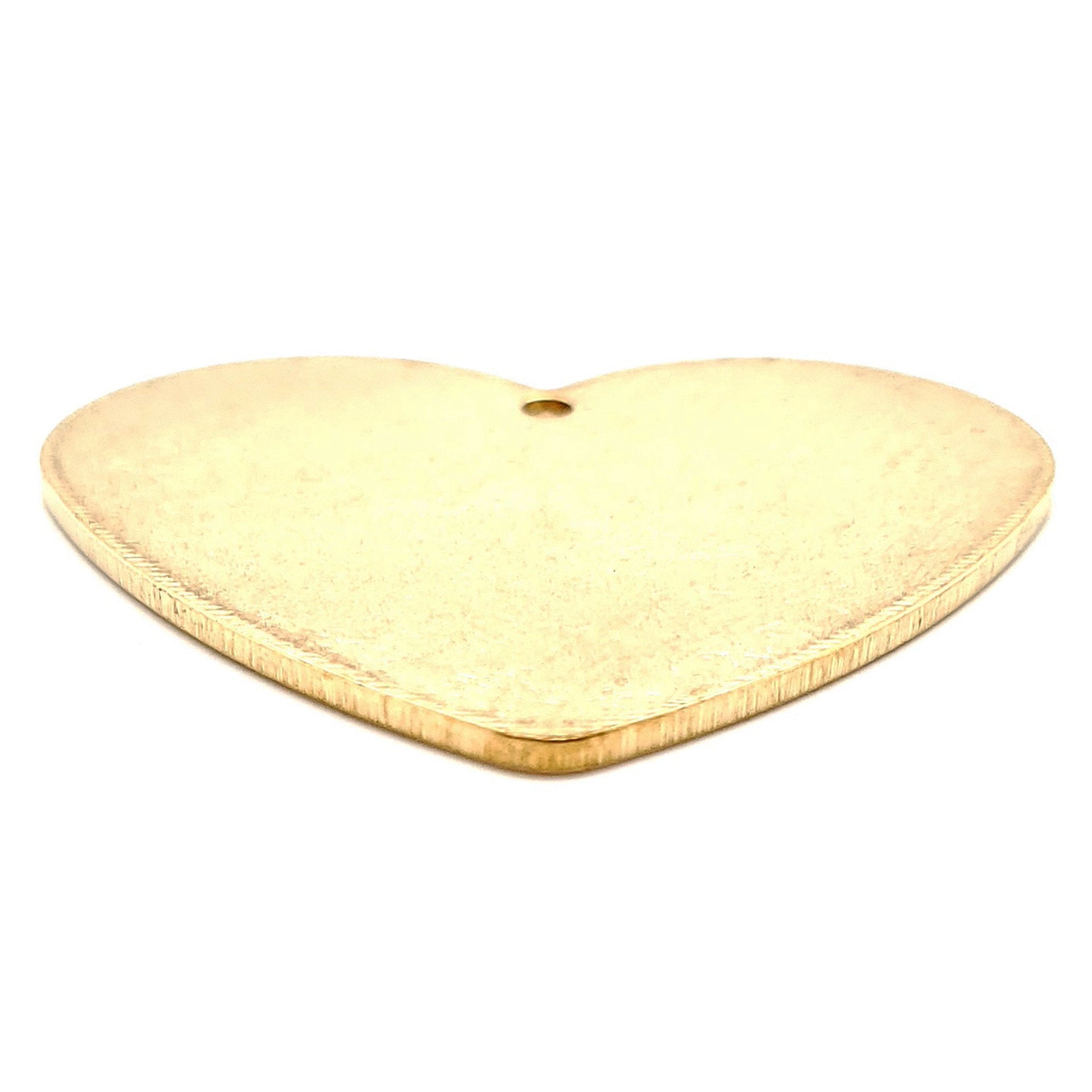 Brass blank holed heart pendant at an angle.