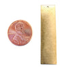 Brass blank vertical rectangle pendant with a penny for scale.