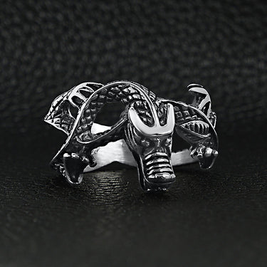 Stainless steel eastern dragon ring on a black leather background.