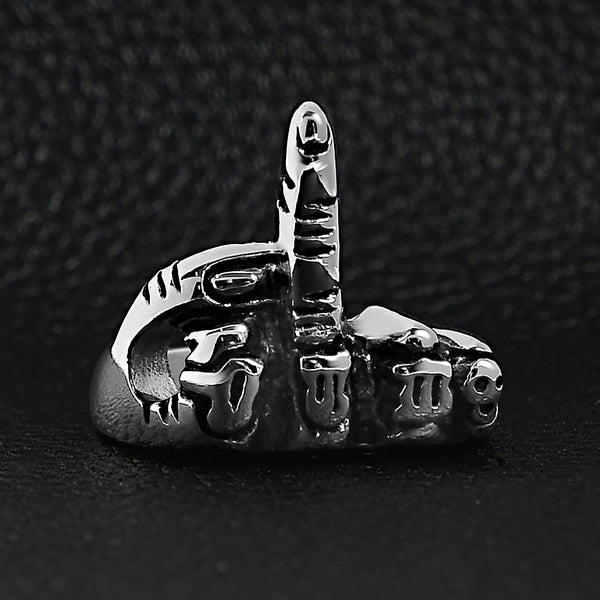 Stainless steel polished FTW middle finger ring on a black leather background.