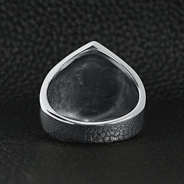 Stainless steel "13" and skulls ring back view on a black leather background.