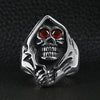 Stainless steel red Cubic Zirconia eyed grim reaper ring on a black leather background.