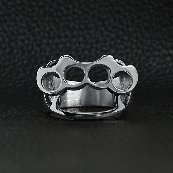 Stainless steel polished knuckle duster ring on a black leather background.
