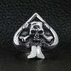 Stainless steel polished skull of spades ace ring on a black leather background.