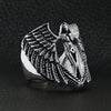 Stainless steel large nude angel ring angled on a black leather background.