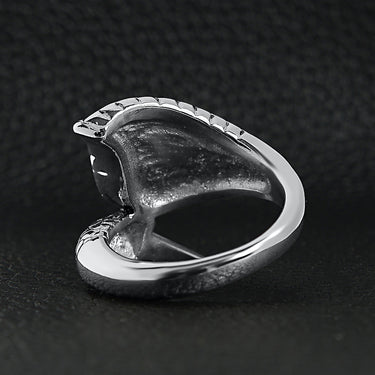 Stainless steel dragon claw and angel wing ring back view on a black leather background.