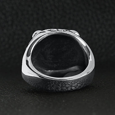 Stainless steel snarling tiger ring back view on a black leather background.