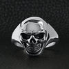 Stainless steel skull women's ring on a black leather background.