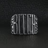 Stainless steel "BITCH" signet ring on a black leather background.