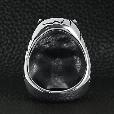 Stainless steel devil skull with red Cubic Zirconia eye smoking 18K gold PVD Coated cigar ring back view on a black leather background.