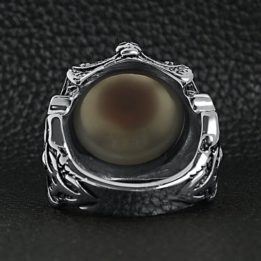Stainless steel gothic red eyeball with claw and skull accents ring back view on a black leather background.