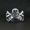 Stainless steel pirate Jolly Roger skull with crossed swords ring on a black leather background.