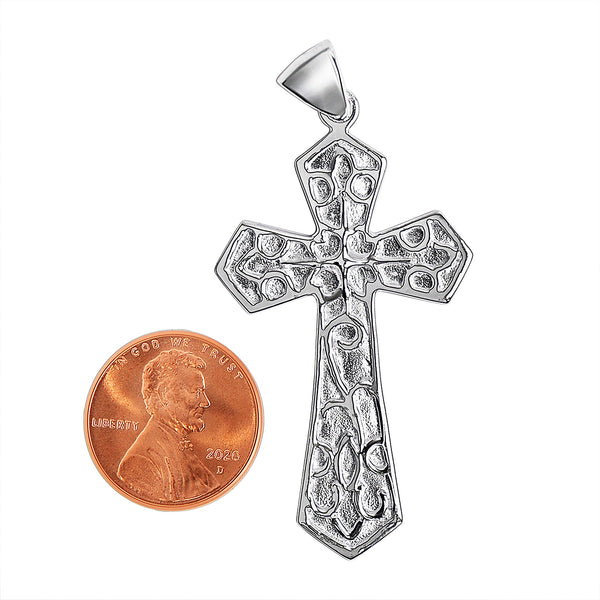 Sterling silver filigree cross pendant with a penny for scale.