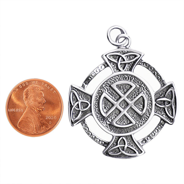 Sterling silver Celtic Quaternary Knot cross pendant with a penny for scale.