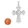 Sterling silver detailed Cross pendant with a penny for scale.