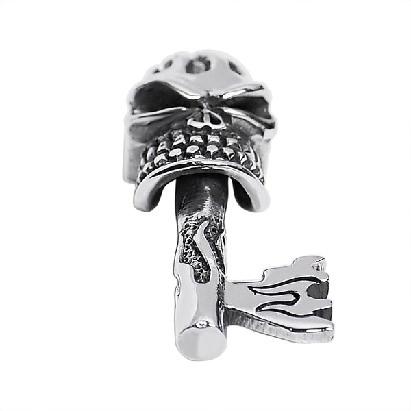Sterling silver skull key pendant at an angle.