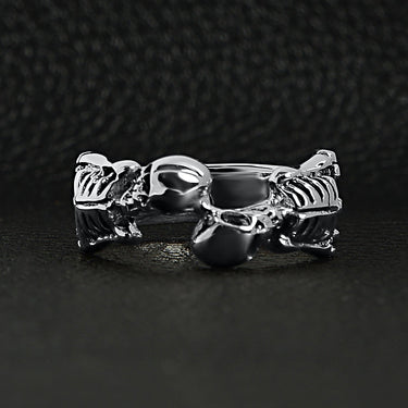 Sterling silver two skeletons ringon a black leather background.