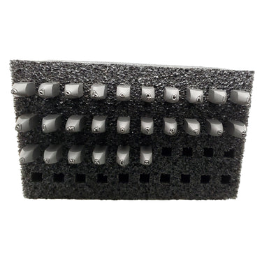 Lowercase alphabet stamp set in a foam block.
