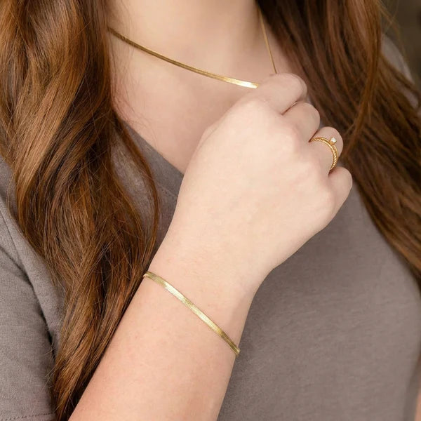 WJW gold necklace, ring and bracelet styled together