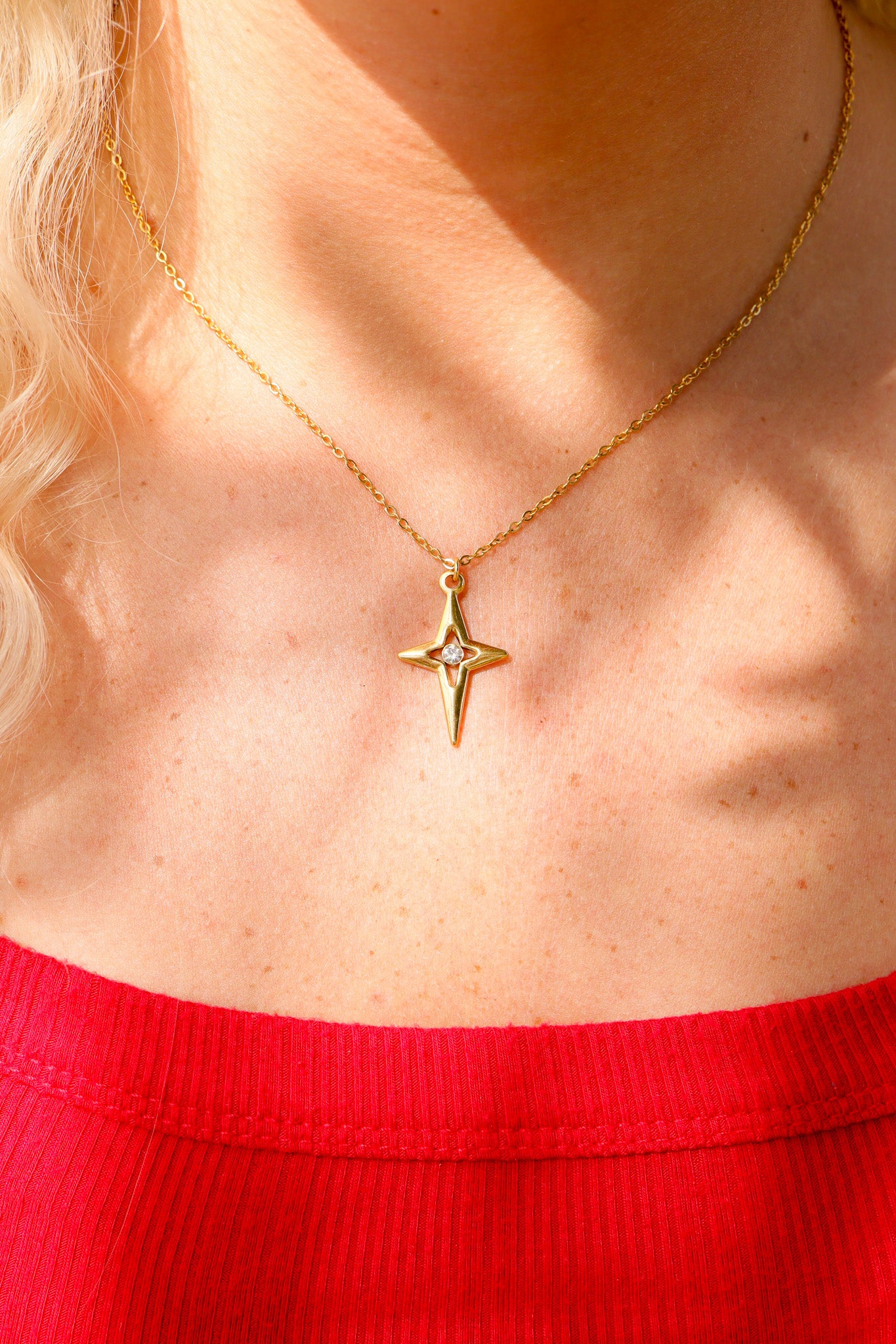 Compass star pendant with CZ stone in center life style