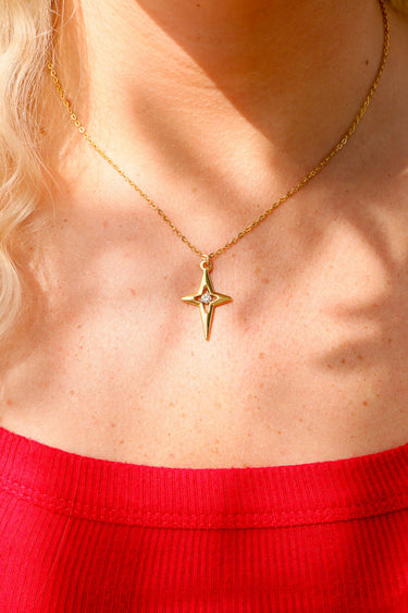 Compass star pendant with CZ stone in center life style