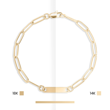 Gold chain bracelet with 18K and 14K markings on a white background