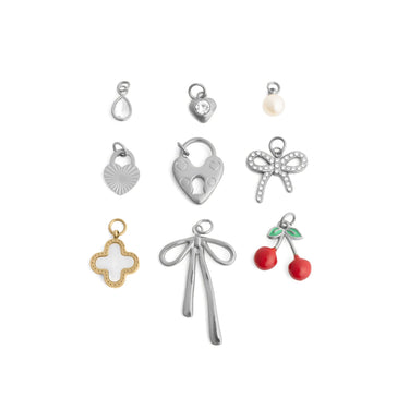 Collection of various silver charms on a white background
