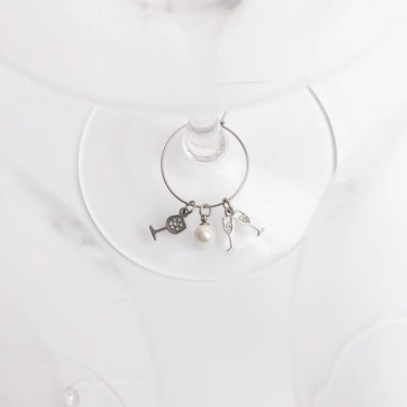 Wine glass charm with charms on a white plate