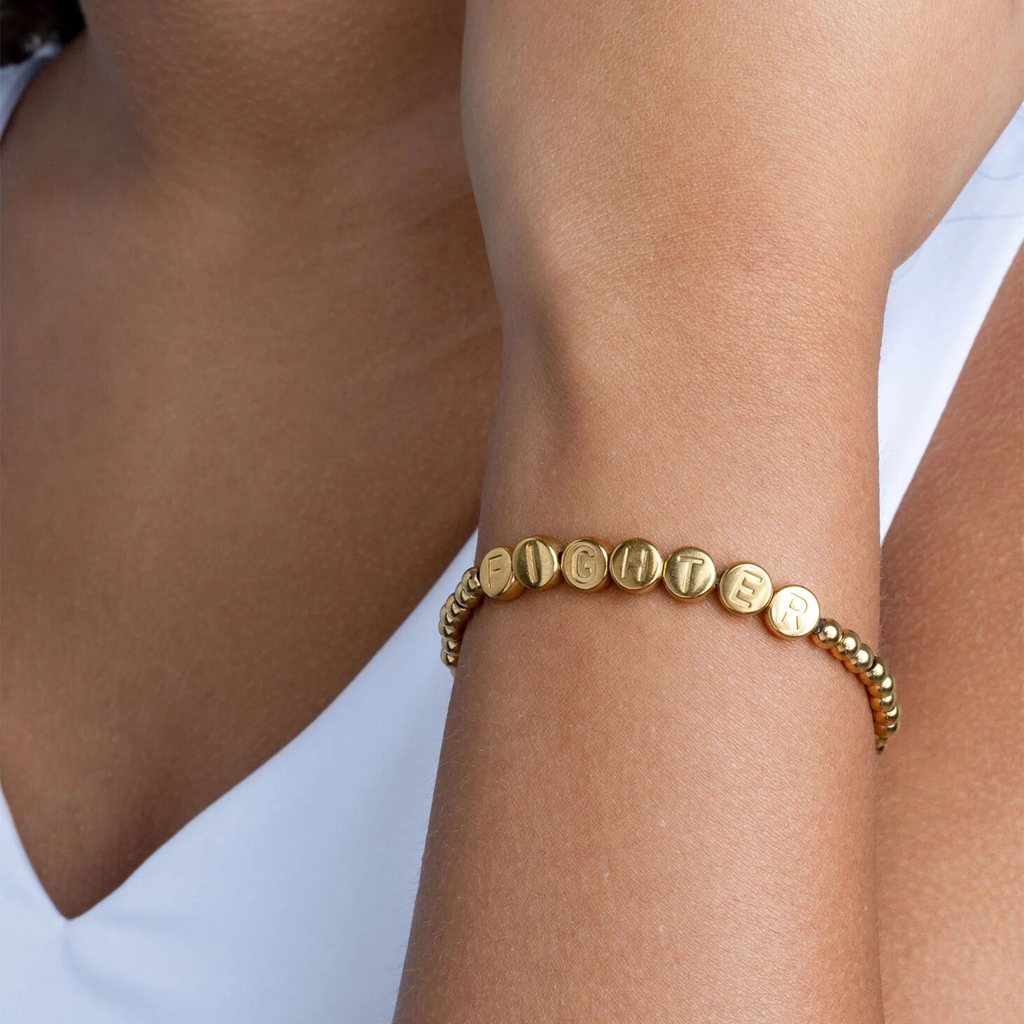 Gold Fighter Metal Beaded Bracelet Gift Set on a wrist against a white background