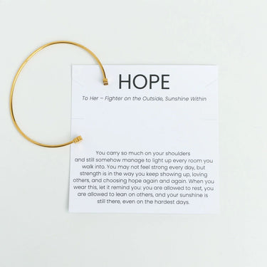 Gold Adjustable Cuff with Cancer Ribbon Charm GIft Set on a white card with 'HOPE' text and message.