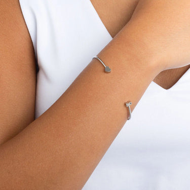 Silver Adjustable Cuff with Cancer Ribbon Charm GIft Seton a person's wrist against a white background