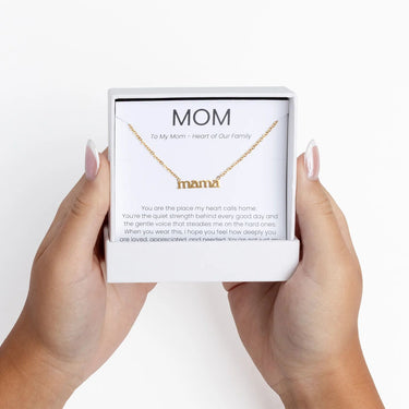 Gold Mama Necklace Gift Set in a 'mama' box held by two hands on a white background