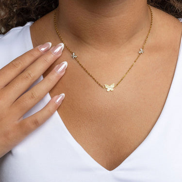 Gold Butterfly Necklace Gift Set Necklace worn by a person with a white top
