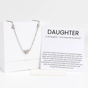 Silver necklace with a butterfly pendant on a card addressed to 'Daughter' with sentimental text.