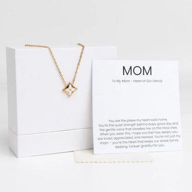 Gold Gold Mother Of Pearl Star Pendant Necklace Gift Set and dust cloth with a card for 'Mom' on a white background
