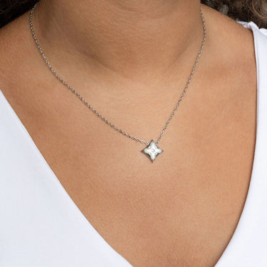 Silver Mother Of Pearl Star Pendant Necklace Gift Set on a person wearing a white top