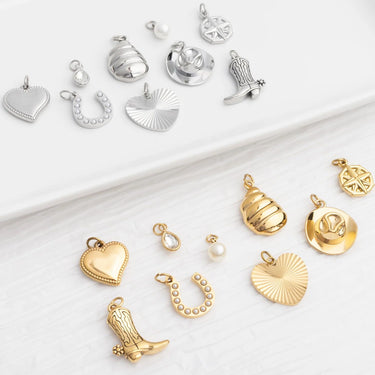 Collection of various gold and silver pendants on a white background