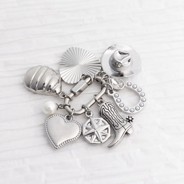 Collection of silver charms on a white background