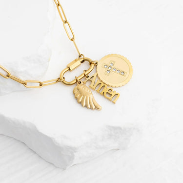 Gold necklace with various charms on a white background