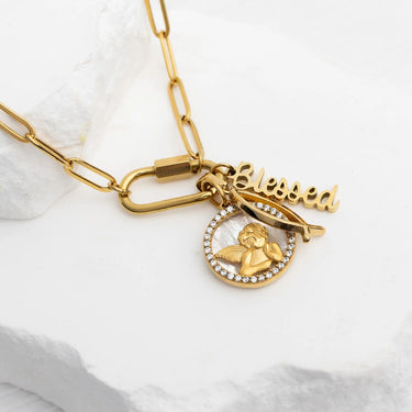 Gold necklace with 'blessed' pendant on a white background