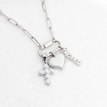 Silver necklace with heart-shaped pendant and 'Eloise' tag on a white background